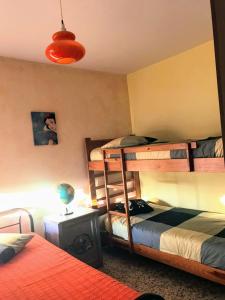 a bedroom with two bunk beds and a lamp at Casita bonita de pescador parking y sabanas en opción in Almería