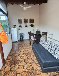 a living room with a couch and a table at Rose House in Arraial do Cabo