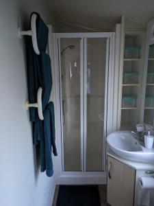 a bathroom with a shower and a sink at Homely 2 bed caravan sleeps 4 5 in Portland Dorset in Portland