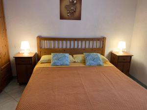 a bedroom with a bed with blue pillows on it at Delizioso appartamento Girasole in Ischia