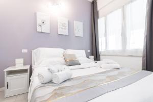 un letto bianco con asciugamani in una camera da letto di VittorioVeneto126 a La Spezia