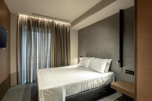 a bedroom with a bed and a large window at Zakro Luxury Living Chania in Chania Town