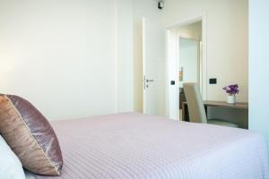 a bedroom with a bed and a desk with a chair at Milena Suite Apartments in Alghero