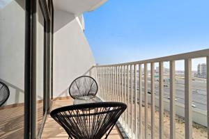 a balcony with a chair and a view of a city at Silkhaus Modern Luxurious Studio at Dubai Silicon Oasis in Dubai