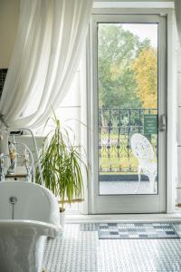 a bathroom with a tub in front of a window at Berwick Lodge in Bristol