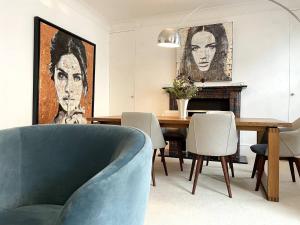 倫敦的住宿－Cozy apartment in Marylebone，一间配备有蓝色沙发和一张桌子的用餐室
