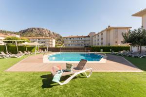 a swimming pool with a lounge chair next to a building at Pierre & Vacances Estartit Playa in L'Estartit