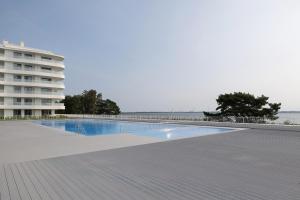 an empty swimming pool next to a building at Rogowo Pearl Turquoise Apartments Near The Sea with FREE PARKING by Renters in Rogowo