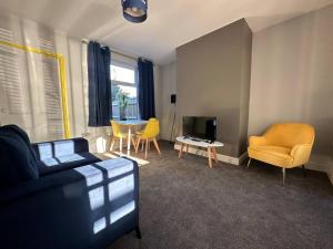 a living room with a couch and chairs and a tv at Home Away From Home - Perfect For Contractors in Newark upon Trent