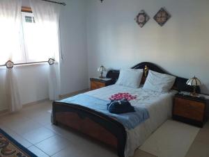 a bedroom with a large bed and a window at Azure Guest House in Silveira