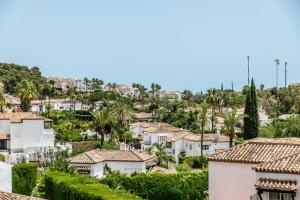 a cityscape of houses and palm trees at 4 bedroom Villa in Top location - Heating Pool in Marbella