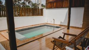 a swimming pool in the middle of a house at Casa reserva boa vista in Barreirinhas