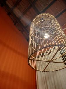 a bird cage hanging from a ceiling at The Jungle House in Arugam Bay