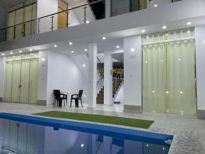 a house with a swimming pool and a table and chairs at Hurin Hotel in Ica