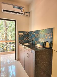 a kitchen with a sink and a counter top at The Regal Luxury Boutique Stays in Majorda