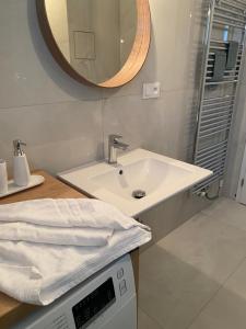 a bathroom with a sink and a mirror at Apartman s terasou, v novostavbe in Prague