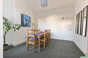 a dining room with a table and chairs at Prime Location Stylish 4-bed House Near Trent Br in Nottingham