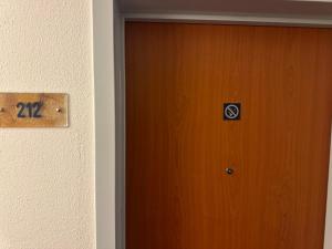 a door with a sign on it next to a wall at Seeblick 212 in Hahnenklee-Bockswiese