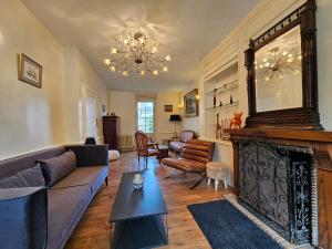a living room with a couch and a fireplace at Soleil du Matin in Étretat