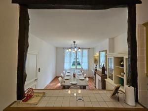a living room with a table in the middle of a room at Soleil du Matin in Étretat