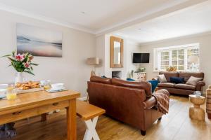 a living room with a couch and a table at Leap House in Wareham