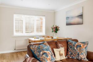 a living room with a couch and a table at Leap House in Wareham