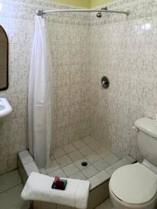 a bathroom with a shower and a toilet at Kay Marni: Your Saint Lucian home in Gros Islet