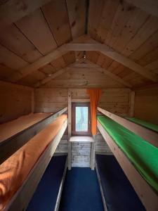 an inside view of a wooden cabin with two beds at Ubytování na Horečky Ranči in Nový Jičín