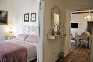 a bedroom with a bed and a dining room at Bed and Breakfast Casa Gioconda in Gaeta +33 photos