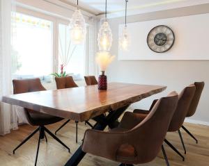 jadalnia z drewnianym stołem i krzesłami w obiekcie Premium 106 m2 Wohnung Top für München/Oberbayern w mieście Geretsried