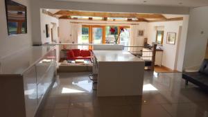 a kitchen with a white counter top in a room at Prestwick Oak - 3 Kingsize Ensuites - Openplan Contemporary Rural Garden in Chiddingfold