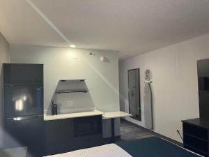 a room with a kitchen with a cash register in it at Studio 6 Suites Norcross, GA in Norcross