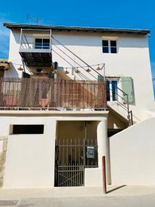 een wit gebouw met een poort en een balkon bij Les Logis de la Combette in Saint-Rémy-de-Provence +47 foto's