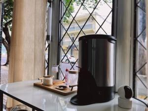 a coffee maker sitting on a counter next to a window at Pousada da Maira in Foz do Iguaçu