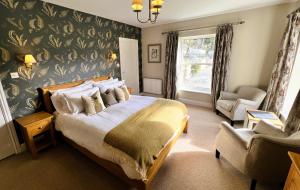 Ein Bett oder Betten in einem Zimmer der Unterkunft Ravenstone Lodge Country House Hotel