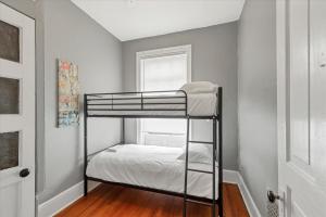 a bunk bed in a room with a window at Historic First Floor Unit in STL - 5 Bedrooms in Soulard