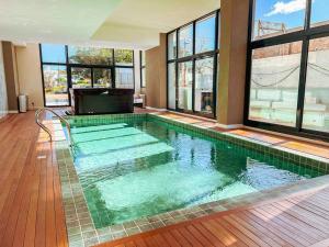 a large swimming pool in a building with windows at View 3 in Punta del Este