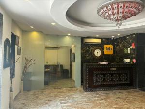 a lobby with a clock on the wall at Tipsyy Inn & Suites Jaipur in Jaipur