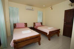 Postel nebo postele na pokoji v ubytování Suan Luang Garden View