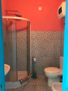 a bathroom with a shower and a toilet and a sink at Djabraba's Eco-Lodge in Vila Nova Sintra