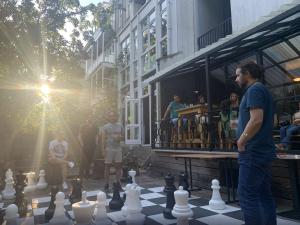 a man standing in front of a giant chessboard at The Arcade Hotel Amsterdam in Amsterdam