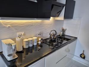 a kitchen with a stove and a counter top at Chłodna Place Apartment in Warsaw