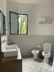 a bathroom with a toilet and a sink and a window at La Justina - Casa de Campo en San Lorenzo in San Lorenzo