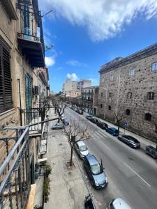 a city street with cars parked on the street at House del Corso Calatafimi in Palermo