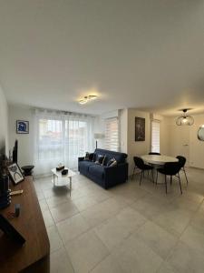 a living room with a couch and a table at Appartement Plein Centre in Saint-Brevin-les-Pins