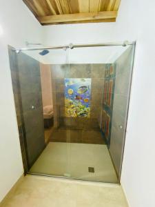 a glass shower with an aquarium in a room at AFRA Reserva Natural in Santa Marta