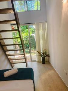a room with a bed and a large window at AFRA Reserva Natural in Santa Marta