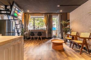 a room with a bar with tables and chairs at SG Hideout Apartment Ben Thanh 374 Nguyen Cong Tru in Ho Chi Minh City