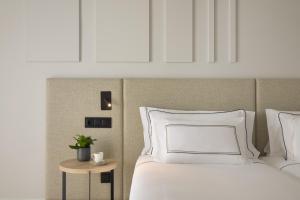 a bedroom with a white bed and a table at Meliá Lloret de Mar in Lloret de Mar