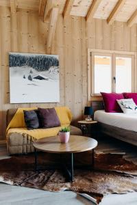a living room with a couch and a table at Le Gîte D'Hélène - Cluses Meublé tourisme 4 étoiles 12 personnes - Haute-Savoie - 30 minutes de Toutes les stations de ski in Cluses
